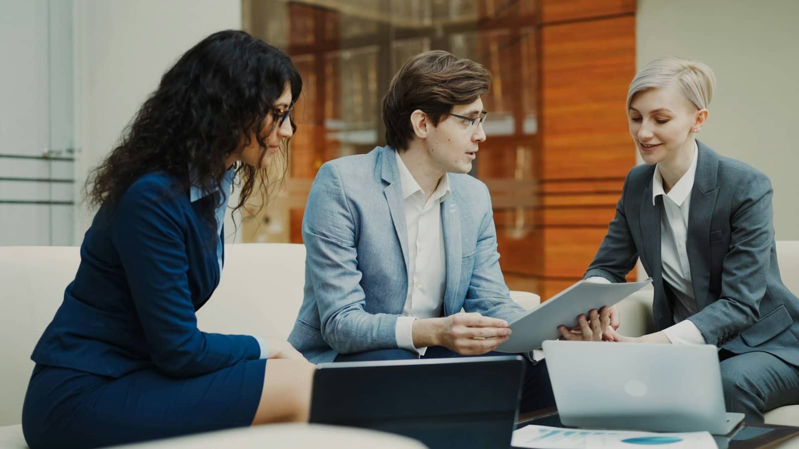 three corporate finance professionals speaking