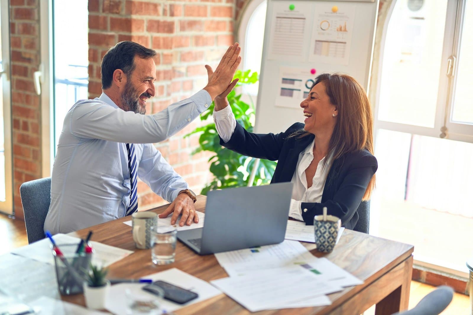 people high fiving over sba7(a) loan